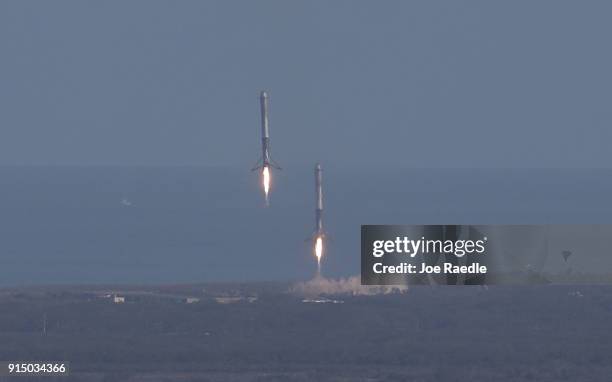 Two of the boosters land at Cape Canaveral Air Force Station after the launch of SpaceX Falcon Heavy rocket from launch pad 39A at Kennedy Space...