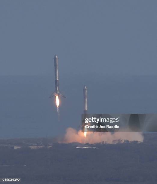 Two of the boosters land at Cape Canaveral Air Force Station after the launch of SpaceX Falcon Heavy rocket from launch pad 39A at Kennedy Space...