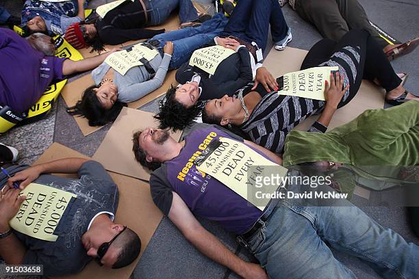 Activists with Health Care for America Now, the California Labor Federation and Service Employees International Union hold a "body pile-up" as they...