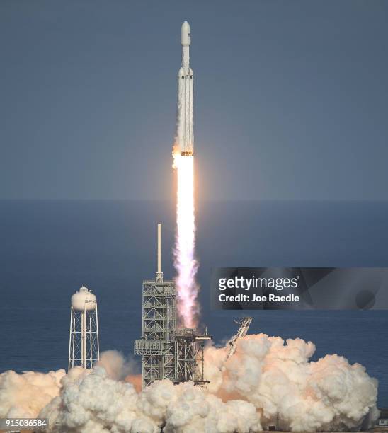The SpaceX Falcon Heavy rocket lifts off from launch pad 39A at Kennedy Space Center on February 6, 2018 in Cape Canaveral, Florida. The rocket is...