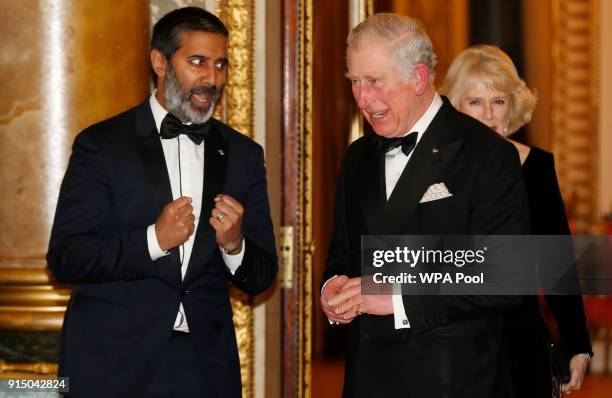 Prince Charles, Prince of Wales speaks to broadcaster Nihal Arthanayake as he arrives for a reception and dinner for the Britain Asian Trust at...