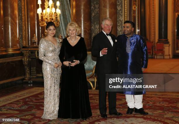 Britain's Prince Charles, Prince of Wales speaks with British music producer Naughty Boy while Britain's Camilla, Duchess of Cornwall speaks with...