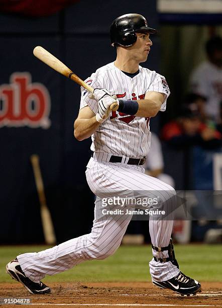 Joe Mauer of the Minnesota Twins doubles during the 1st inning of the American League Tiebreaker game against the Detroit Tigers on October 6, 2009...