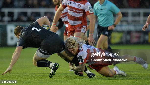 Richard Hibbard of Gloucester Rugby tackles Kyle Cooper of Newcastle Falcons during the Anglo-Welsh Cup match between Newcastle Falcons and...