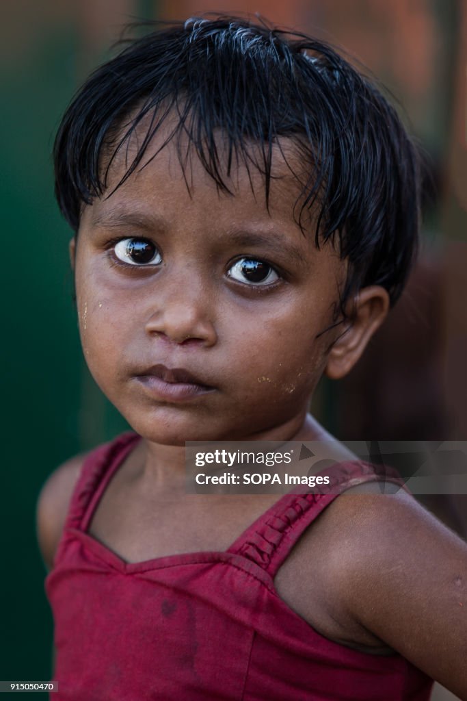 A young Rohingya girl seen posing for a photo in Kutupalong...