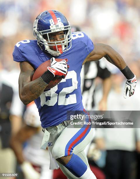 Mario Manningham of the New York Giants runs with the ball against the Washington Redskins during their game on September 13, 2009 at Giants Stadium...