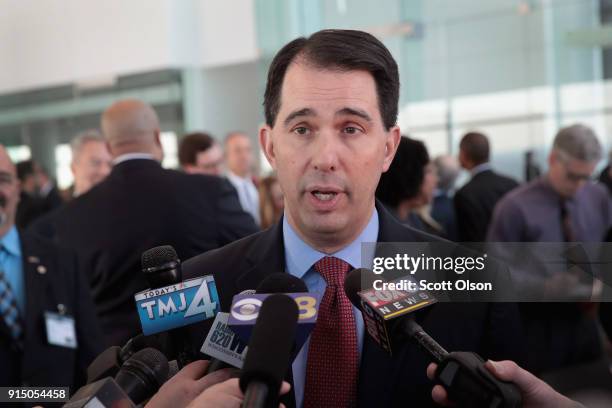 Wisconsin Governor Scott Walker speaks to the press at an event held to announce Foxconn's plan to purchase an office building from Northwestern...