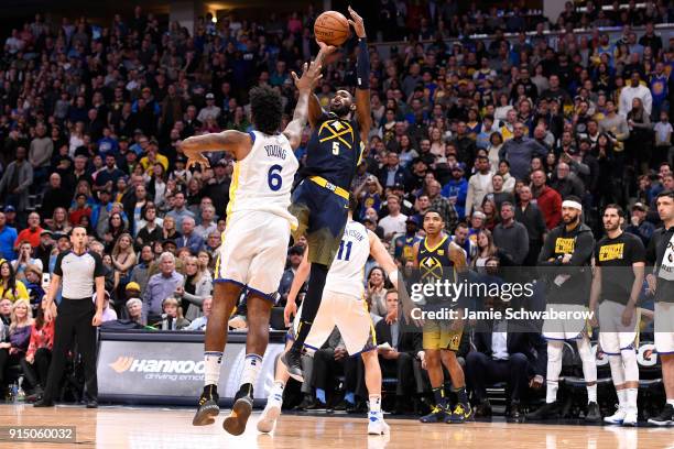 Will Barton of the Denver Nuggets shoots over Nick Young of the Golden State Warriors at Pepsi Center on February 3, 2018 in Denver, Colorado. NOTE...