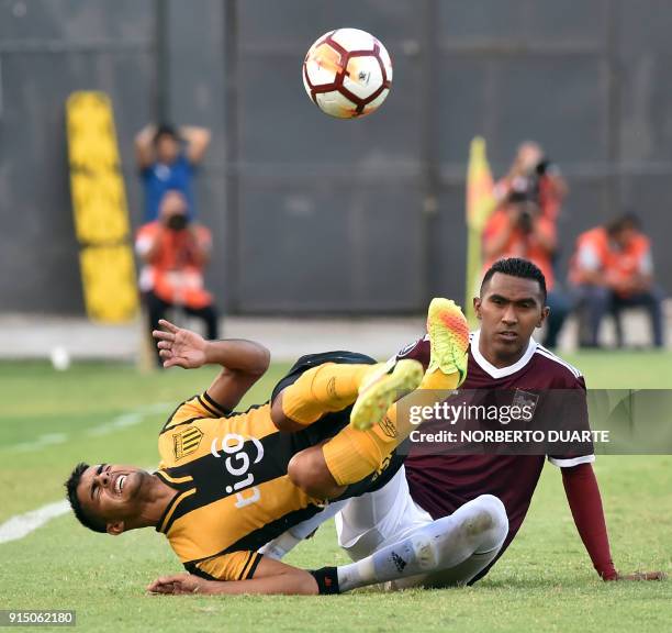Venezuela's Carabobo player Jose Hernandez vies for the ball with Paraguay's Guarani Miguel Benitez during their Copa Libertadores football match at...