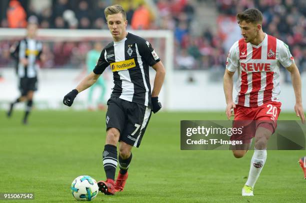 Patrick Herrmann of Moenchengladbach and Salih Oezcan of Koeln battle for the ball during the Bundesliga match between 1. FC Koeln and Borussia...