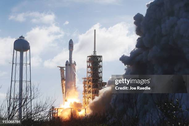 The SpaceX Falcon Heavy rocket lifts off from launch pad 39A at Kennedy Space Center on February 6, 2018 in Cape Canaveral, Florida. The rocket is...