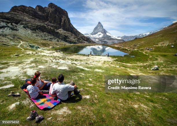 family in front of the matterhorn, switzerland. - swiss alps summer stock pictures, royalty-free photos & images