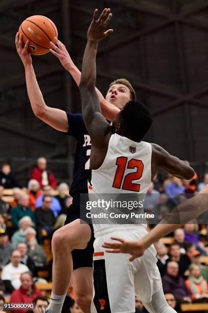 Ryan Betley of the Pennsylvania Quakers drives to the basket against Myles Stephens of the Princeton Tigers during the first half at L. Stockwell...