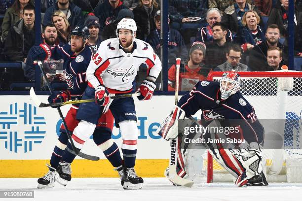 Brandon Dubinsky of the Columbus Blue Jackets and Tom Wilson of the Washington Capitals battle for position as goaltender Sergei Bobrovsky of the...