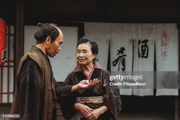 japanese couple in a traditional village - fusuma doors stock pictures, royalty-free photos & images