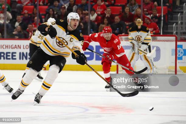 Zdeno Chara of the Boston Bruins makes a pass in front of Gustav Nyquist of the Detroit Red Wings during the first period at Little Caesars Arena on...