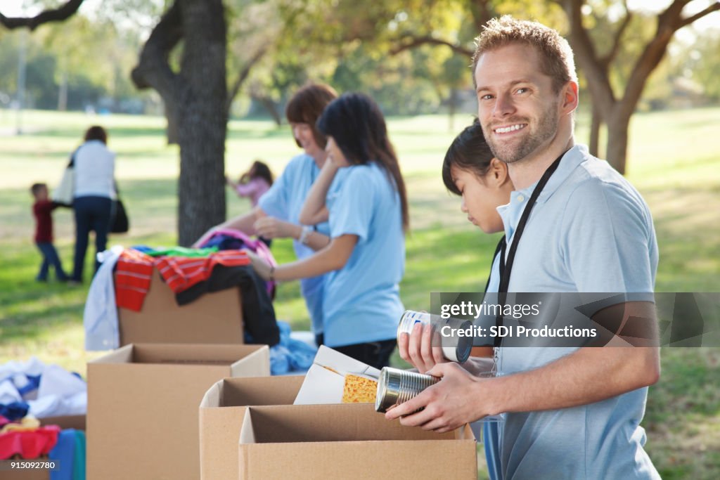 Young man volunteering during food and clothing drive