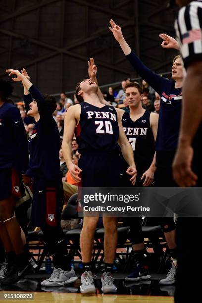 Matt MacDonald of the Pennsylvania Quakers reacts with his team on the bench to a three point basket against the Princeton Tigers during the second...