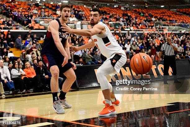 Max Rothschild of the Pennsylvania Quakers passes the ball against Jerome Desrosiers of the Princeton Tigers during the second half at L. Stockwell...