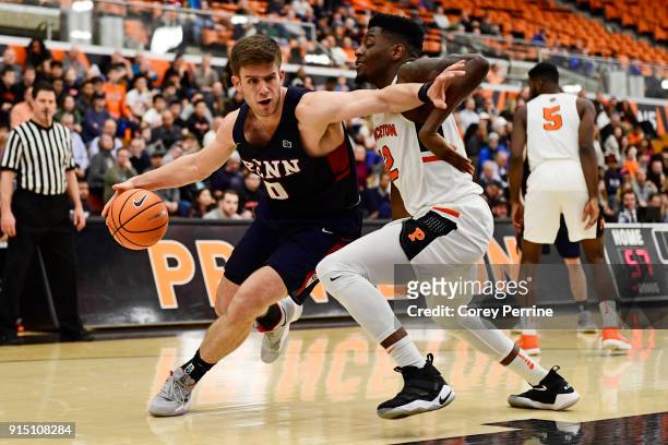 Max Rothschild of the Pennsylvania Quakers drives to the basket against Myles Stephens of the Princeton Tigers during the second half at L. Stockwell...