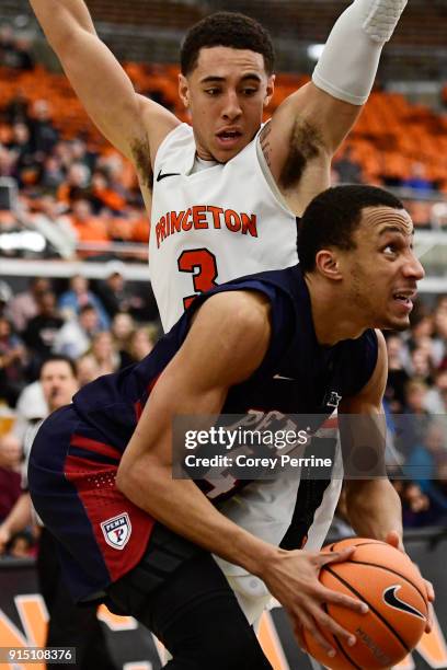 Darnell Foreman of the Pennsylvania Quakers works his way past Devin Cannady of the Princeton Tigers during the second half at L. Stockwell Jadwin...