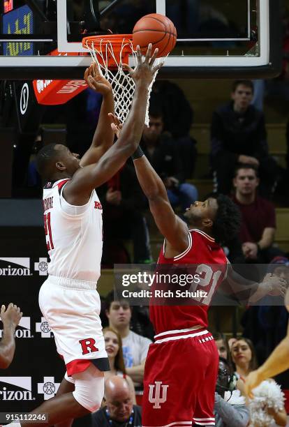 Mamadou Doucoure of the Rutgers Scarlet Knights attempts a shot as Freddie McSwain Jr. #21 of the Indiana Hoosiers defends during the first half of a...