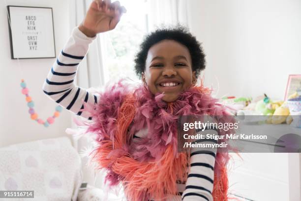gelukkig meisje met boas dansen thuis - boa persoonlijk accessoire stockfoto's en -beelden