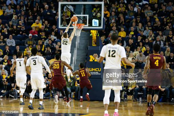 Michigan Wolverines guard Duncan Robinson goes in for a layup during a regular season Big 10 Conference basketball game between the Minnesota Golden...