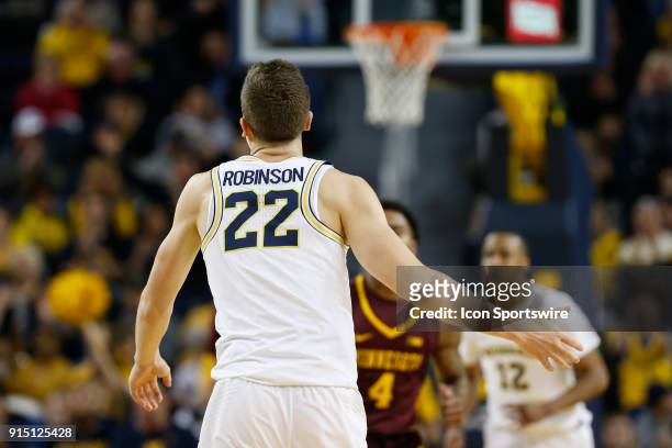 Michigan Wolverines guard Duncan Robinson looks on during a regular season Big 10 Conference basketball game between the Minnesota Golden Gophers and...