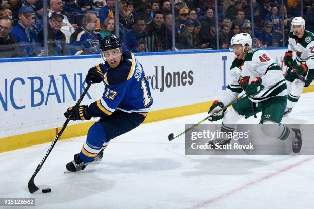 Jaden Schwartz of the St. Louis Blues controls the puck as Jared Spurgeon of the Minnesota Wild defends at Scottrade Center on February 6, 2018 in...