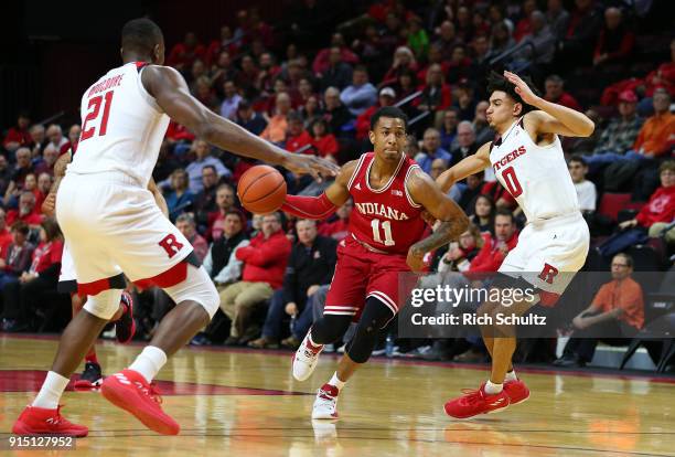 Devonte Green of the Indiana Hoosiers in action against Mamadou Doucoure and Geo Baker of the Rutgers Scarlet Knights during a game at Rutgers...