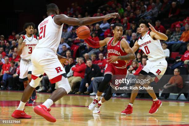Devonte Green of the Indiana Hoosiers in action against Mamadou Doucoure and Geo Baker of the Rutgers Scarlet Knights during a game at Rutgers...