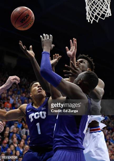 Udoka Azubuike of the Kansas Jayhawks battles for a rebound against Desmond Bane and Kouat Noi of the TCU Horned Frogs in the first half at Allen...