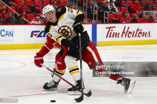 Riley Nash of the Boston Bruins tries to get around Henrik Zetterberg of the Detroit Red Wings during the third period at Little Caesars Arena on...