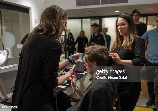 Model prepares backstage at the Perry Ellis fashion show during New York Fashion Week Mens' at The Hippodrome Building on February 6, 2018 in New...