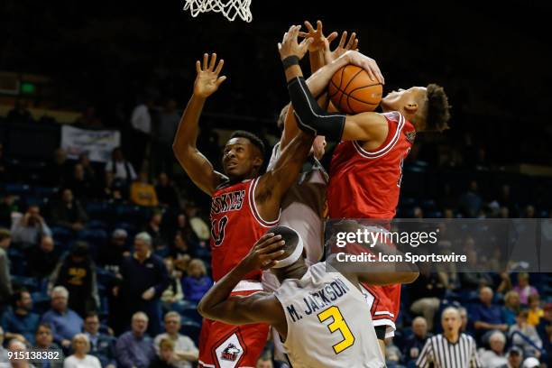 Northern Illinois Huskies forward Lacey James and Northern Illinois Huskies guard Eugene German battle to grab a rebound against Toledo Rockets...