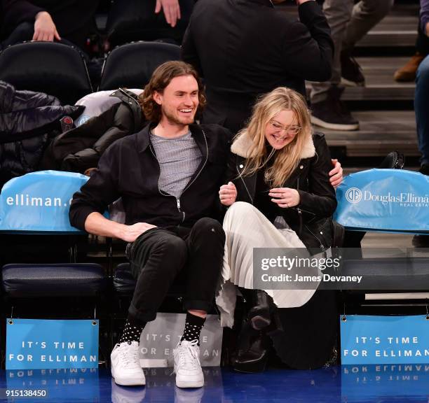 Henry Frye and Dakota Fanning attend the New York Knicks vs Milwaukee Bucks game at Madison Square Garden on February 6, 2018 in New York City.