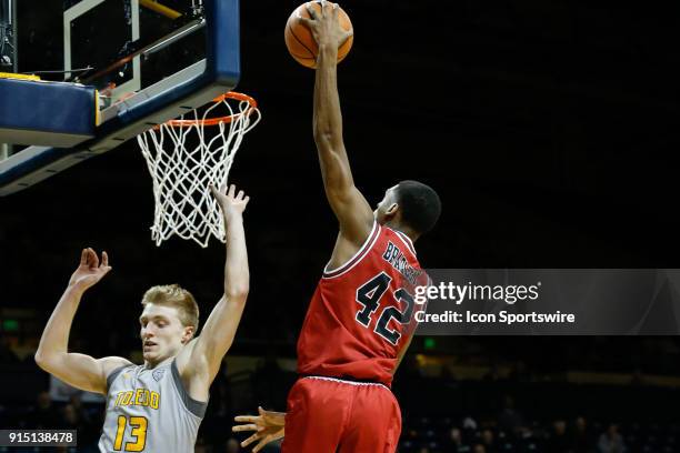 Northern Illinois Huskies forward Levi Bradley goes in for a layup against Toledo Rockets guard Jaelan Sanford during the second half of a regular...