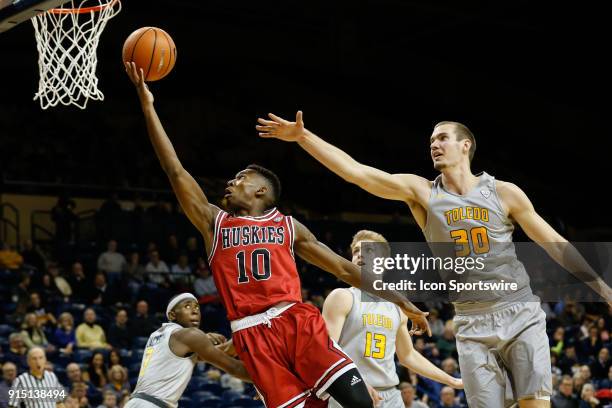 Northern Illinois Huskies guard Eugene German goes in for a layup against Toledo Rockets forward Luke Knapke during the second half of a regular...