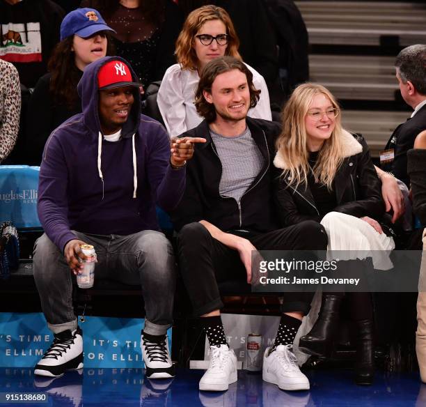 Michael Che, Henry Frye and Dakota Fanning attend the New York Knicks vs Milwaukee Bucks game at Madison Square Garden on February 6, 2018 in New...