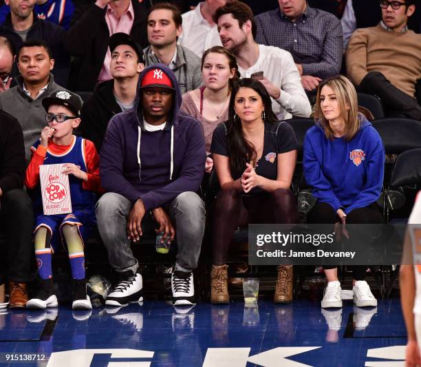 Michael Che and Cecily Strong attend the New York Knicks vs Milwaukee Bucks game at Madison Square Garden on February 6, 2018 in New York City.