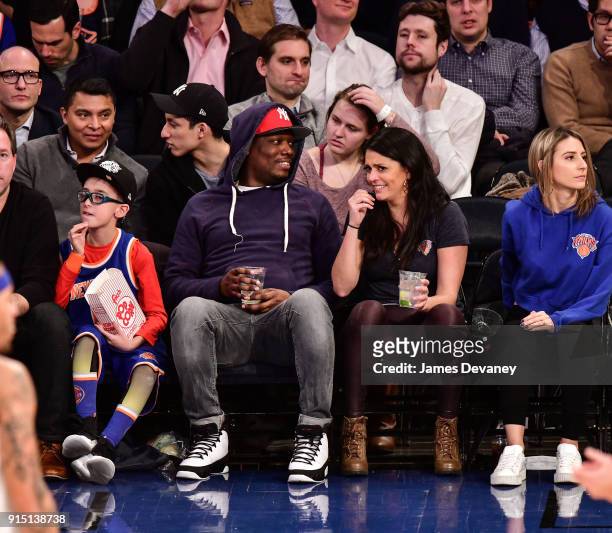 Michael Che and Cecily Strong attend the New York Knicks vs Milwaukee Bucks game at Madison Square Garden on February 6, 2018 in New York City.