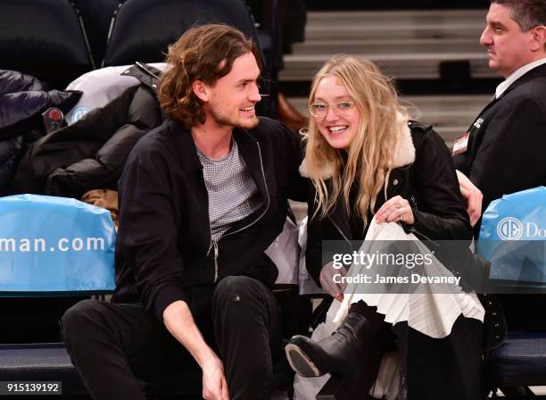 Henry Frye and Dakota Fanning attend the New York Knicks vs Milwaukee Bucks game at Madison Square Garden on February 6, 2018 in New York City.