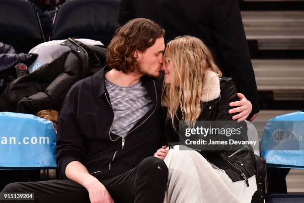 Henry Frye and Dakota Fanning attend the New York Knicks vs Milwaukee Bucks game at Madison Square Garden on February 6, 2018 in New York City.