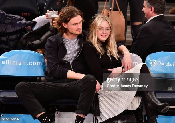 Henry Frye and Dakota Fanning attend the New York Knicks vs Milwaukee Bucks game at Madison Square Garden on February 6, 2018 in New York City.