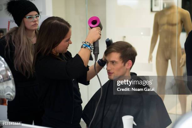 Model prepares backstage at the Perry Ellis fashion show during New York Fashion Week Mens' at The Hippodrome Building on February 6, 2018 in New...
