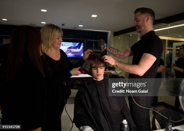 Model prepares backstage at the Perry Ellis fashion show during New York Fashion Week Mens' at The Hippodrome Building on February 6, 2018 in New...