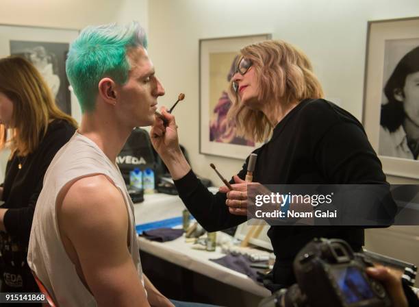 Prepares backstage at the Perry Ellis fashion show during New York Fashion Week Mens' at The Hippodrome Building on February 6, 2018 in New York City.