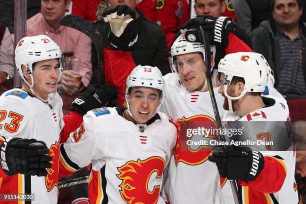 Sean Monahan, Johnny Gaudreau, Michael Stone and TJ Brodie of the Calgary Flames celebrate after Stone scored against the Chicago Blackhawks in the...