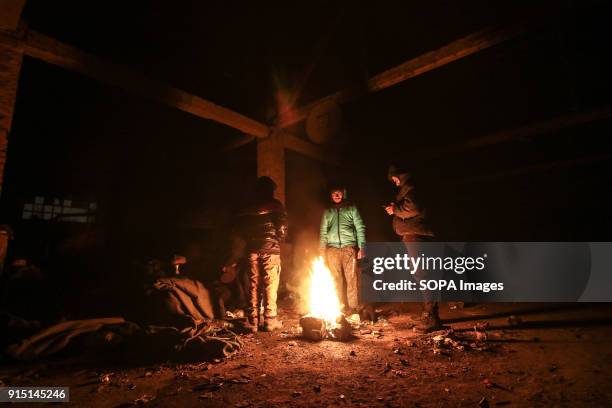 Refugees and migrants light a fire inside former barracks in Belgrade. The barracks were used as shelter by refugees and migrants. Serbia is a...